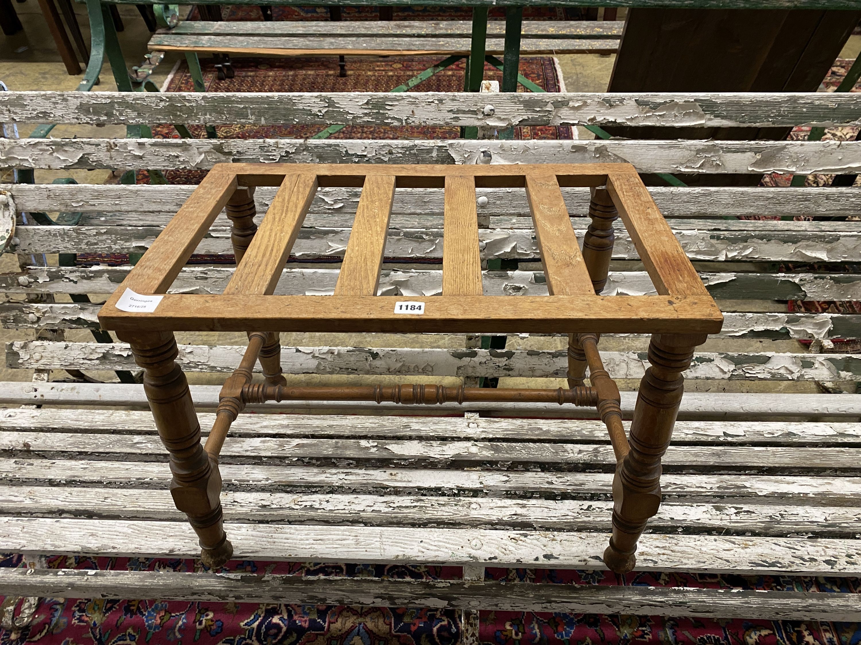 An early 20th century oak luggage stand